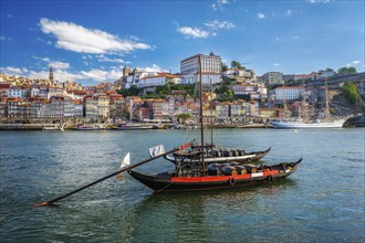 View of Porto city and Douro river with traditional boats with port wine barrels and sailing ship