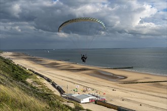 Paragliders along the dunes of Zoutelande, in Zeeland, South Holland, Netherlands