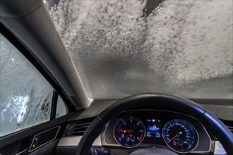 Car in an automatic car wash, car wash tunnel