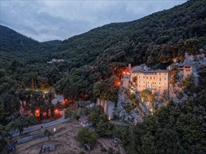 Illuminated at dusk is the Santuario di Greccio hermitage, also known as the Santuario Francescano