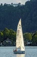 Sailing boat on Lake Tegernsee, warm evening light, above Ringberg Castle, heritage-protected