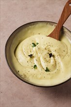 Mashed potatoes, with micro greenery and spices, homemade, on a beige table, no people, top view