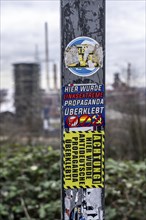 Stickers of right-wing extremist groups pasted over stickers of apparently left-wing groups,