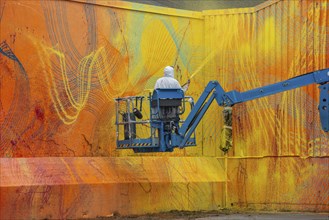 American street artist Douglas Hoekzema, also known as HOXXOH paints a wall in Ystad, Skåne County,