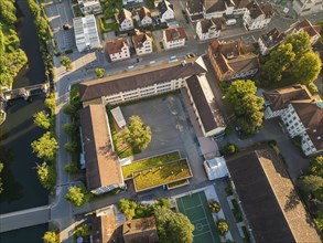 Aerial view of a school complex with playground, surrounded by buildings and trees, Nagold, Black