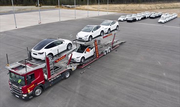 Tesla Y models produced in the Tesla Giga Factory are loaded onto car transporters, Grünheide, 24