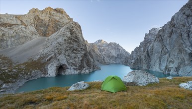 Wild camping, camping in the wilderness with a tent in front of mountain lake Kol Suu, Sary Beles