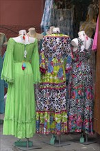 Colourful dresses in front of a fashion shop in the harbour of Portofino, Italy, Europe