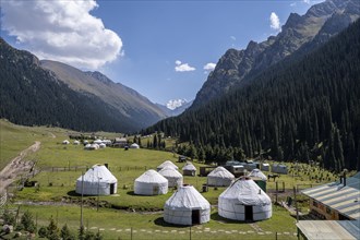 Yurts for tourists in the village of Altyn Arashan, green mountain valley, Tien Shan Mountains,