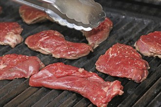 Raw steak on the grill