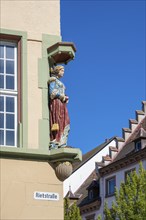 Figure, statue of a chic lady at a town house and former department stores' Josef Boss in the