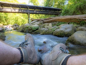 The Irrel Waterfalls, rapids in the lower reaches of the Prüm, covered wooden bridge for hikers,