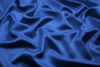 Blue silk lies in soft, irregular folds