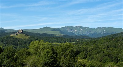 View of the medieval castle of Murol and the Sancy massif in the Auvergne Volcanoes Regional