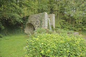 Bridge with water pipe from Schaumburger Bach, Balduinstein, Lahn, Rhineland-Palatinate, Germany,