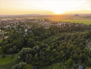 A village surrounded by fields and forest at sunset, Allstedt, Harz, Germany, Europe