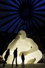 Illuminated Denker statue in the Sony Center at Potsdamer Platz for the Festival of Light, Berlin,