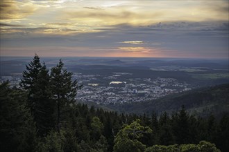 The sun rises behind clouds over the small town of Ilmenau in the Thuringian Forest. Ilmenau, 26.07