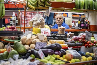 Vendor and display of fruit and vegetables at a market stall, Mercado Central de San José, San