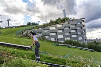 CopenHill, waste incineration plant and artificial ski slope, skiing with a view of the ski lift,