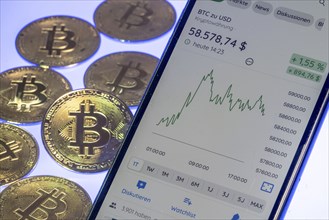 Bitcoin cryptocurrency, symbol coin, mobile phone, mobile phone with Bitcoin currency rates, to the