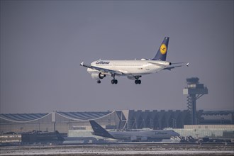 Lufthansa Airbus A320-200 approaching Frankfurt FRA airport, air traffic control tower, Fraport, in