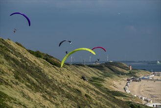 Paragliders along the dunes of Zoutelande, in Zeeland, South Holland, Netherlands