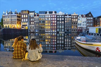 Canal houses on the Damrak, in the centre of the old town of Amsterdam, harbour, starting point of