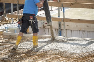 Construction site, concreting, the floor slab of a building is concreted, the concrete is pumped