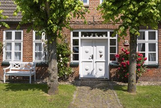 Resting place in the garden, Beautiful facade on a North German house, Föhr, North Sea island,