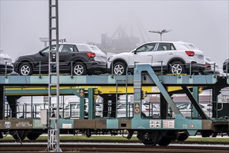 Freight train, car transporter brings new cars from Germany, for export by ship, to the port of