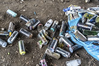 Paint cans, leftover rubbish from graffiti sprayers, under the motorway bridge, the A43 over the