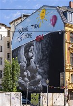 Artistically painted house facade with political background, Oranienburger Straße, Berlin, Germany,