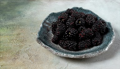 Fresh blackberry berry, on a plate, top view, no people