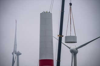 Construction of the tower of a wind power plant in a wind farm near Issum, 9 older wind turbines