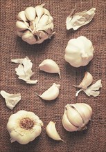 Garlic on burlap, top view, vertical, rustic style, no people