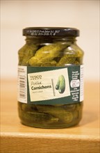 Glass jar of Tesco pickled Cornichons showing label, UK