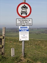 Road signs and car thieves warning sign, Ridgeway at Hackpen Hill, Wiltshire, England, UK