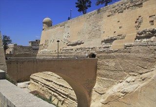 Bridge crossing moat to fortified city walls, Saint James bastion, Valletta, Malta, Europe