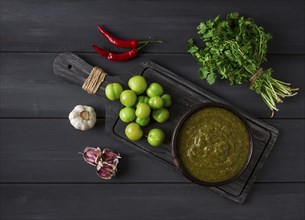 Tkemali sauce, traditional Georgian cuisine, green cherry plum, with ingredients for sauce,