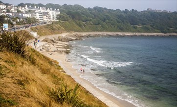 People walking on Castle Beach, Falmouth, Cornwall, England, UK