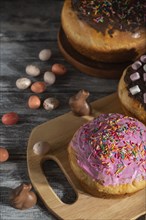 Homemade glazed and decorated easter pies with chocolate eggs and rabbits on a gray wooden