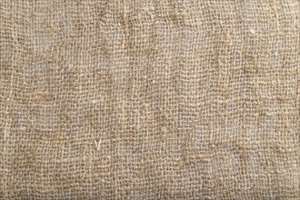 Fragment of smooth brown linen tissue. Top view, flat lay, natural textile background and texture