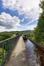 Narrowboat, canal boat with tourists on Pontcysyllte Aqueduct, navigable trough bridge, Llangollen