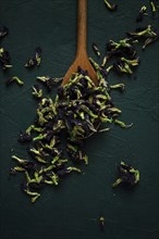 Thai, blue tea, butterfly pea tea, Anchan, wooden spoon, on a dark table, top view