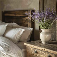 Lavender flowers (Lavendula) in a vase on a bedside table next to a bed, rustic, rural ambience, AI