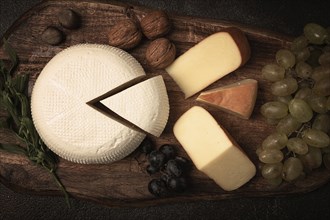 Georgian cheese, Imeretian and smoked suluguni, grapes, nuts, on a cutting board, Georgian cuisine,