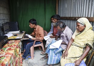 People checks their names in a roadside DTP centre, in the published final list of National