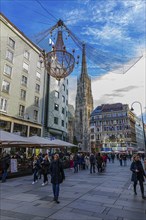 Christmas lights and passers-by in the Graben pedestrian zone, St Stephen's Cathedral in the