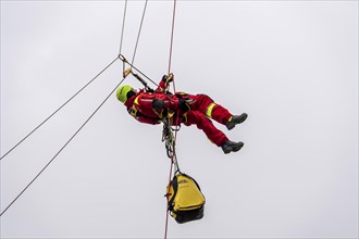 Height rescuers from the Oberhausen fire brigade practise abseiling from a wind turbine from a